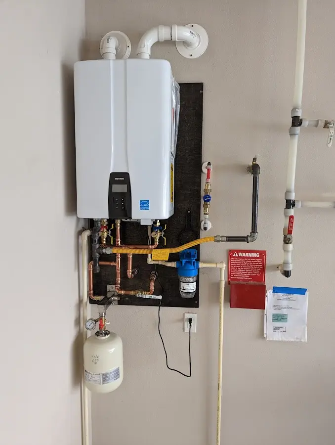 Professional plumber installing copper piping in a River Road home